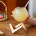 Sophisticated Round Cocktail Glass with Elegant Wooden Stand - Ideal for Creative Drinks and Smoothies