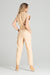 Elegant Beige Sleeveless Jumpsuit with Dropped Shoulders and Stylish Waist Belt