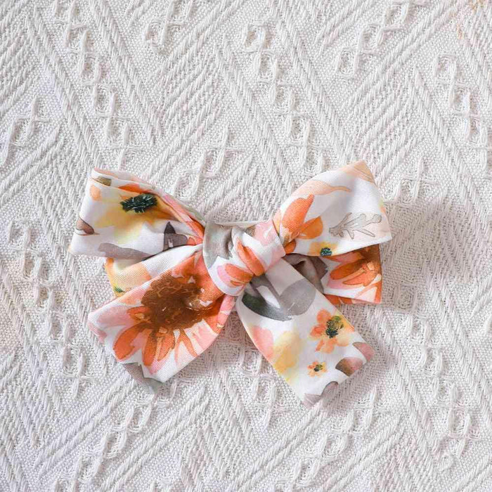 Delightful Floral Bow Baby Romper with Fun Pom-Pom Details